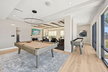 A pool table is in the middle of a room with a billiard table.